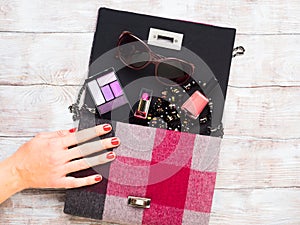 Lady`s clutch bag with make up accessories