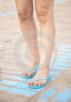 Lady& x27;s feet in sandals on beach