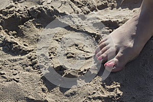 Lady& x27;s feet in sandals on beach