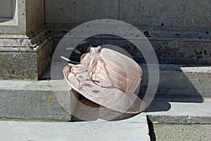 Lady`s hat resting on church step, wedding still life