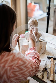 Lady sculptor working in her studio, ceramis artist`s hands