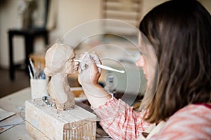 Lady sculptor working in her studio, ceramis artist`s hands