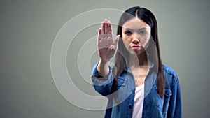 Lady showing stop sign, fighting against racial and gender discrimination rights