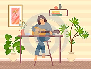 Lady sits in apartment and plays musical instrument. Woman playing acoustic guitar at home