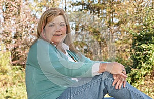 Lady sits and poses outdoors in fall