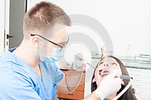 Lady sitting in dentist chair having a professional brushing fro