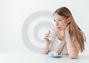 Lady sitting isolated near sweeties drinking coffee