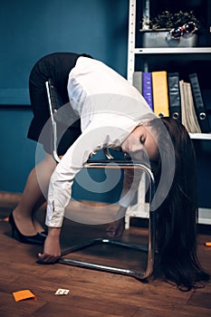 Lady sleeping on chair in weird pose.