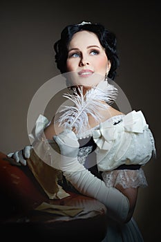 A lady with a smile in a historical costume with a feather in her hand and a letter. Design for the cover of the book.