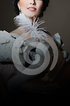 A lady with a smile in a historical costume with a feather in her hand and a letter. Design for the cover of the book.