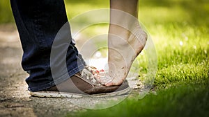 Lady standing barefoot on tip toes on her lovers shoes