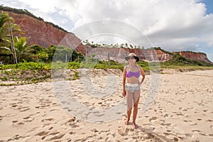 Lady standing at the beach known as Taipe in Brazil