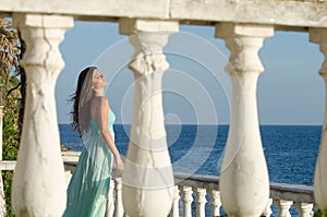 Lady standing on veranda of a beachfront home