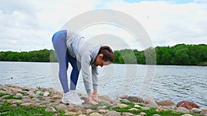 lady stretches legs and touches ground with fingers