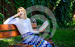 Lady student read boring literature outdoors. Boring literature. Woman yawning blonde take break relaxing in garden