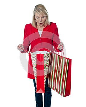 Lady surprised to see empty shopping bag