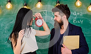 Lady teacher and strict schoolmaster care about discipline and rules in school. School rules concept. Man with beard