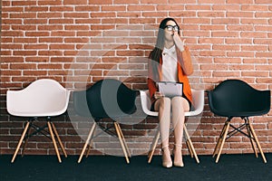 Lady is tired to wait job interview in hall