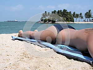 Lady topless sunbathing