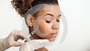 Lady undergoing a facial treatment with syringe