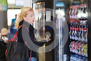 Lady using a modern vending machine