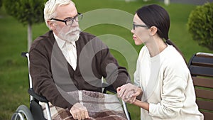 Lady visiting granddad in nursing home veteran suffering post traumatic syndrome photo