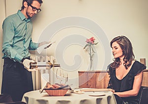 Lady and waiter in restaurant