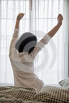 Lady wake up stretch oneself lazily for fresh morning