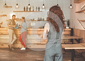 Lady watching her man flirting with girl in cafeteria