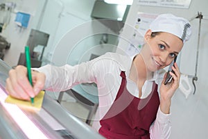 Lady wearing apron taking telephone order