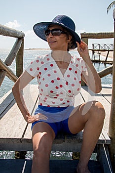 Lady Wearing a Blue Hat Near the Beach