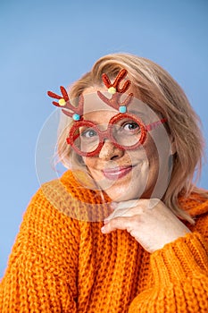 Lady wearing funky glasses smiling excited and looking forward to the holiday