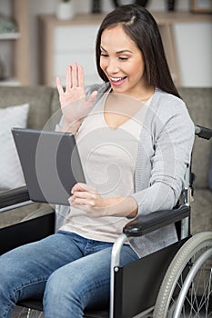 lady in wheelchair using tablet