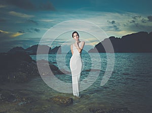 Lady in white dress on a seashore