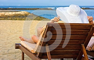 Lady in white hat on the beach