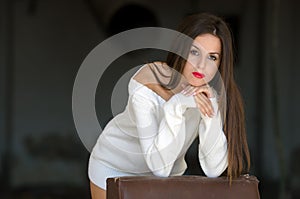 Lady with white long blouse in old factory dark room