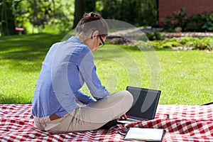 Lady working on computer in garden