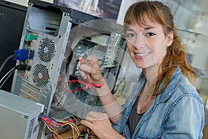 Lady working on dismantled computer