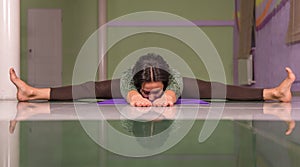 Lady works out yoga stretches in the gym