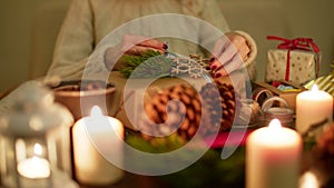 Lady is Wrapping a Christmas Present at Decorated Festive Table. 4K