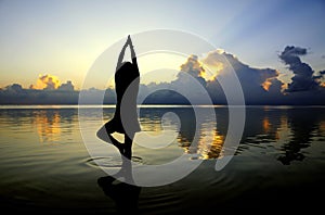 Lady yoga figure with sunset scene