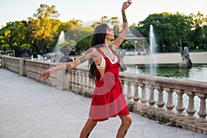 Ladyboy tattooed transgender model is dancing in the green park