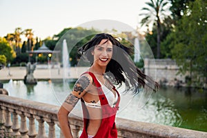 Ladyboy tattooed transgender model is dancing in the green park