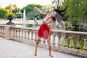 Ladyboy tattooed transgender model is dancing in the green park