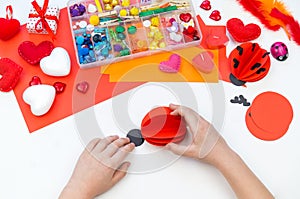Ladybug made of paper craft. Red love symbol. Children`s hand-made