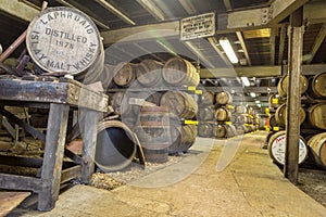 Lafroaig old wooden barrels and casks in cellar at whisky distillery in Scotland