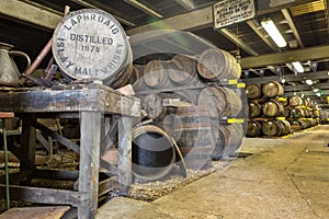 Lafroaig old wooden barrels and casks in cellar at whisky distillery in Scotland