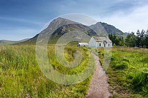 Lagangarbh wee white Hut in mid summer with blue sky, Glencoe, Scotland