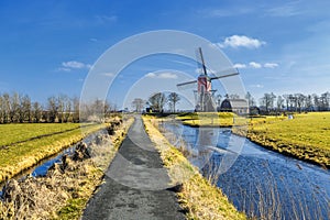 Lagenwaardse historic smock mill in Dutch polder landscape photo