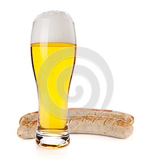 Lager beer glass and two grilled sausages